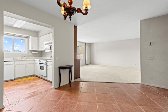 4428 Skimmer Way, Oceanside, CA 92057 - kitchen featuring white appliances, light countertops, light tile patterned floors, open floor plan, and white cabinetry