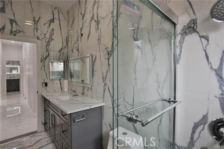 1226212266 Madras Pl, Garden Grove, CA 92840 - bathroom featuring a marble finish shower, vanity, and marble tiled flooring