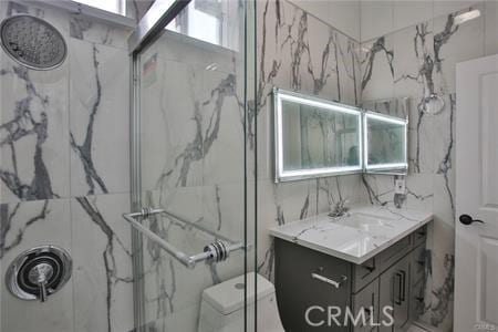 1226212266 Madras Pl, Garden Grove, CA 92840 - full bathroom featuring a marble finish shower, vanity, and tile walls