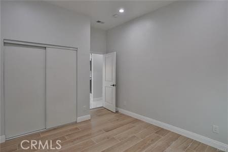 1226212266 Madras Pl, Garden Grove, CA 92840 - unfurnished bedroom with light wood-type flooring, recessed lighting, a closet, and baseboards