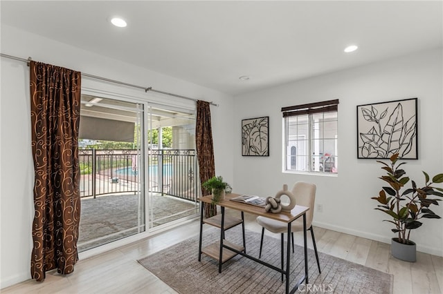 office space with light wood-type flooring, baseboards, and recessed lighting
