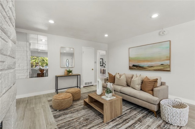 living room with wood finished floors, visible vents, and recessed lighting
