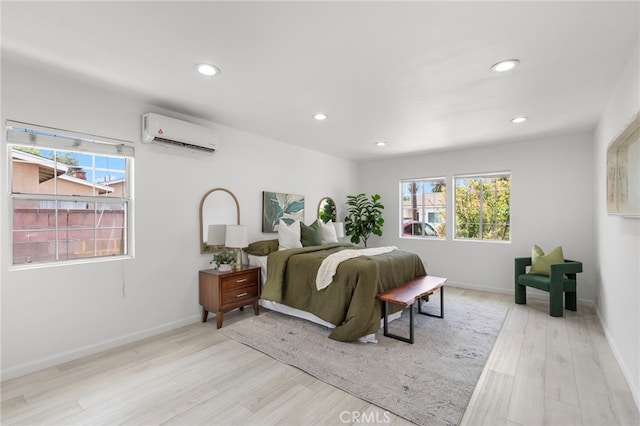 bedroom with a wall mounted air conditioner, recessed lighting, multiple windows, and light wood-type flooring