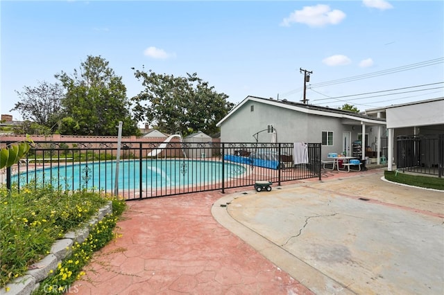 view of swimming pool with fence, a fenced in pool, and a patio