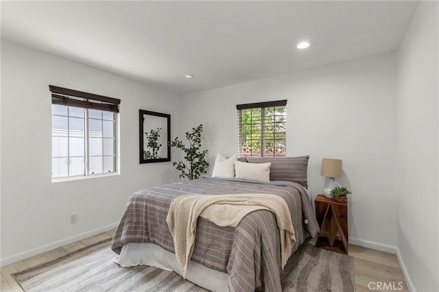 bedroom featuring recessed lighting, wood finished floors, and baseboards