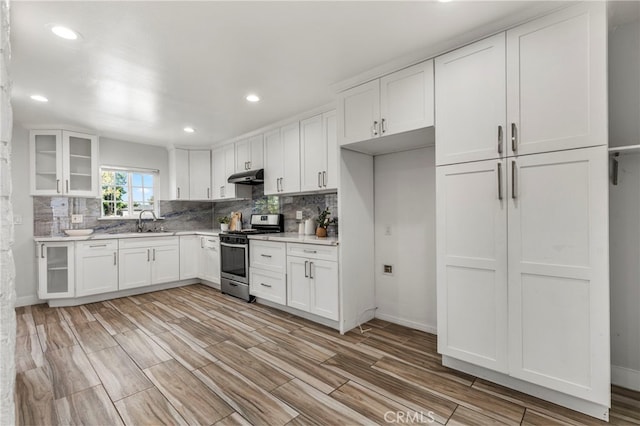 1226212266 Madras Pl, Garden Grove, CA 92840 - kitchen featuring stainless steel range with gas stovetop, under cabinet range hood, a sink, light countertops, and decorative backsplash