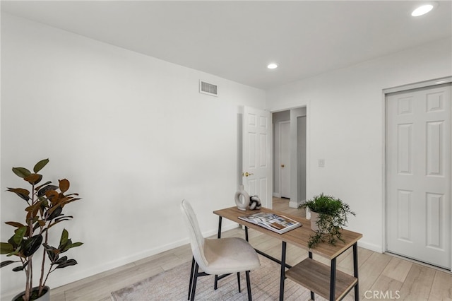 office space featuring baseboards, visible vents, recessed lighting, and light wood-style floors