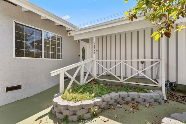 property entrance with stucco siding