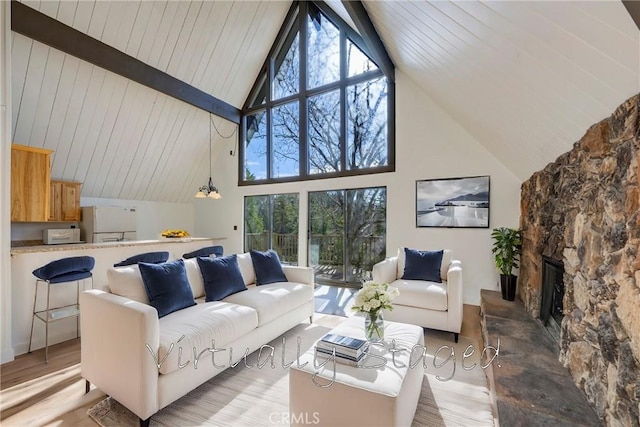 743 Rhine Rd, Lake Arrowhead, CA 92352 - living room with light wood-type flooring, high vaulted ceiling, beamed ceiling, and a fireplace