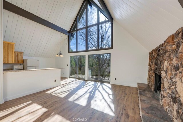 743 Rhine Rd, Lake Arrowhead, CA 92352 - unfurnished living room featuring plenty of natural light, a fireplace, baseboards, and wood finished floors