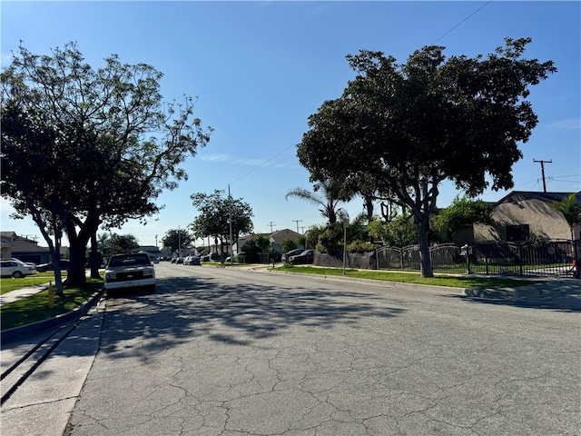 3509 Greenglade Ave, Pico Rivera, CA 90660 - view of asphalt road with curbs, sidewalks, and a residential view