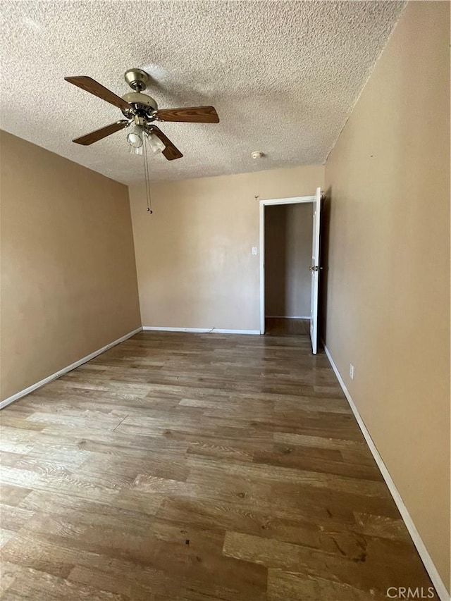 3509 Greenglade Ave, Pico Rivera, CA 90660 - empty room with wood finished floors, ceiling fan, a textured ceiling, and baseboards