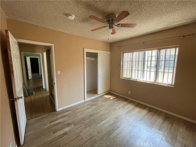 3509 Greenglade Ave, Pico Rivera, CA 90660 - unfurnished bedroom featuring wood finished floors, a textured ceiling, a closet, and baseboards