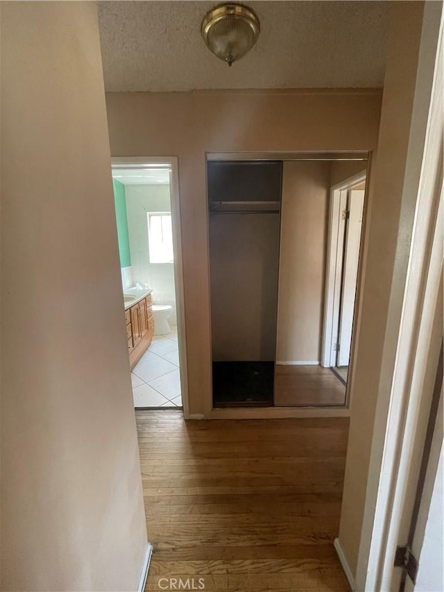 3509 Greenglade Ave, Pico Rivera, CA 90660 - hall featuring light wood-style floors and a textured ceiling