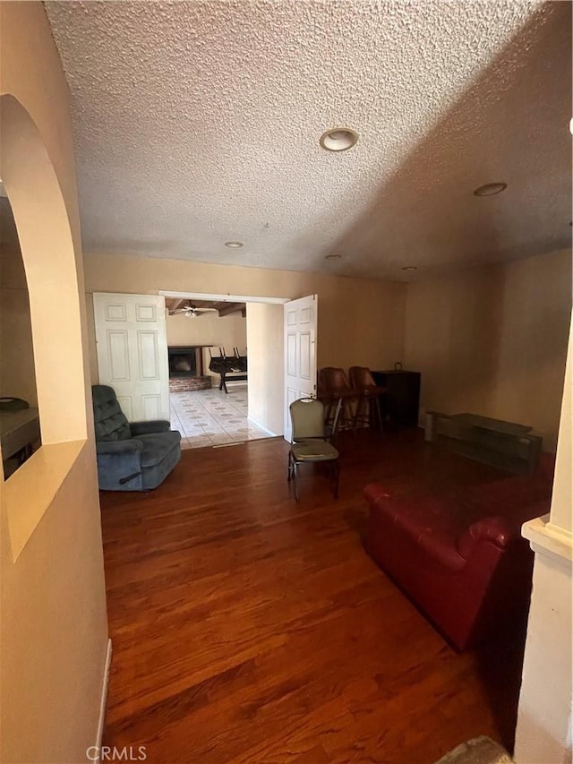 3509 Greenglade Ave, Pico Rivera, CA 90660 - living room with a textured ceiling, wood finished floors, and arched walkways