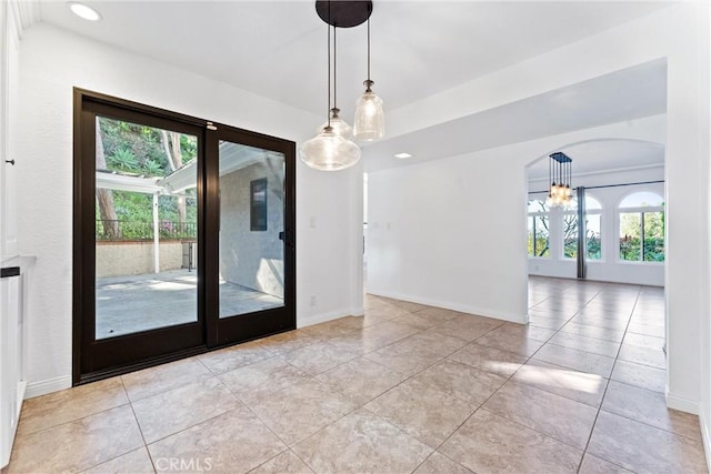 interior space with recessed lighting, baseboards, a notable chandelier, and light tile patterned floors