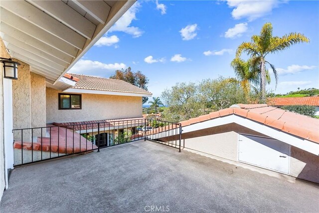 view of patio featuring a balcony