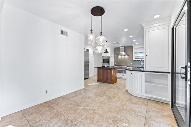 kitchen with decorative backsplash, visible vents, dark countertops, open shelves, and wall chimney exhaust hood