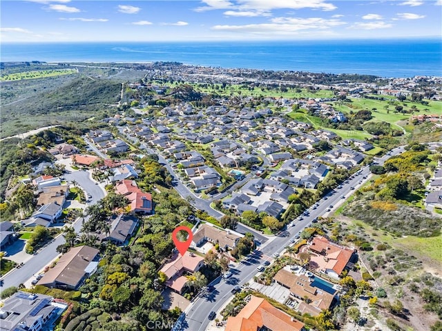 drone / aerial view with a water view and a residential view