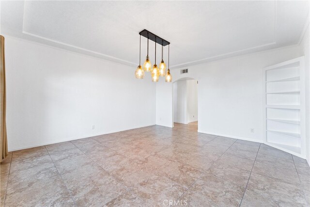 empty room featuring a notable chandelier, arched walkways, built in shelves, visible vents, and ornamental molding