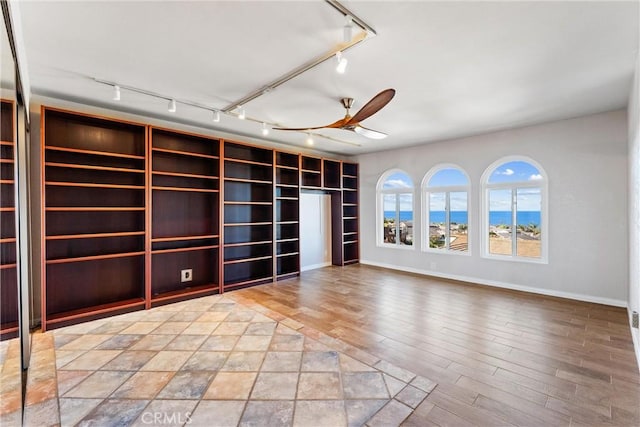 604 Avenida Acapulco, San Clemente, CA 92672 - spare room with track lighting, ceiling fan, baseboards, and wood finished floors
