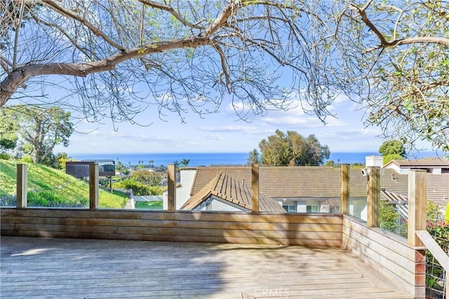 wooden terrace featuring a water view