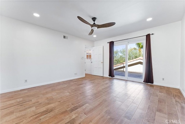 spare room featuring a ceiling fan, baseboards, visible vents, and light wood-style flooring