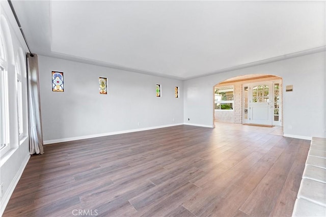 604 Avenida Acapulco, San Clemente, CA 92672 - unfurnished living room with arched walkways, wood finished floors, and baseboards
