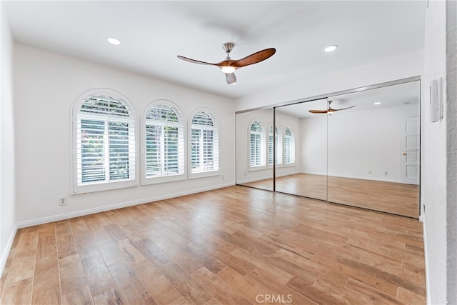 unfurnished bedroom featuring baseboards, recessed lighting, a ceiling fan, and wood finished floors