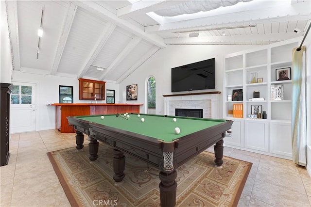 rec room featuring light tile patterned floors, pool table, vaulted ceiling with beams, and a fireplace