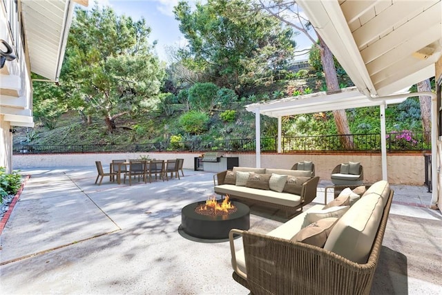 view of patio featuring an outdoor living space with a fire pit