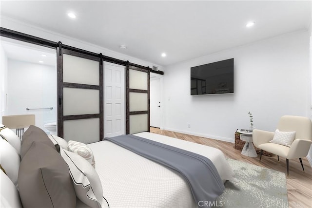 604 Avenida Acapulco, San Clemente, CA 92672 - bedroom featuring a barn door, baseboards, recessed lighting, light wood finished floors, and ensuite bathroom
