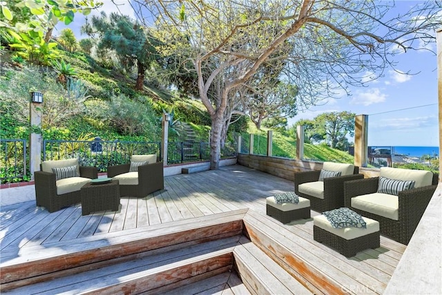 wooden terrace with outdoor lounge area and a fenced backyard
