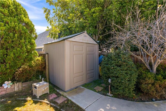view of shed with fence