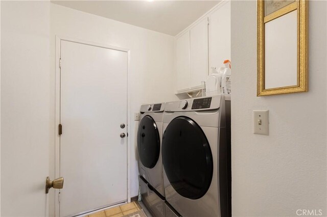 washroom featuring cabinet space and separate washer and dryer