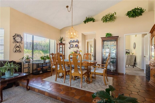 dining area featuring a chandelier and lofted ceiling