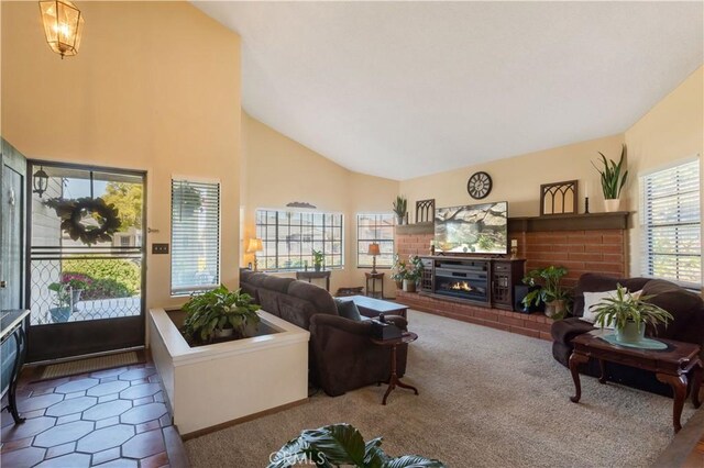 carpeted living area featuring high vaulted ceiling and a fireplace