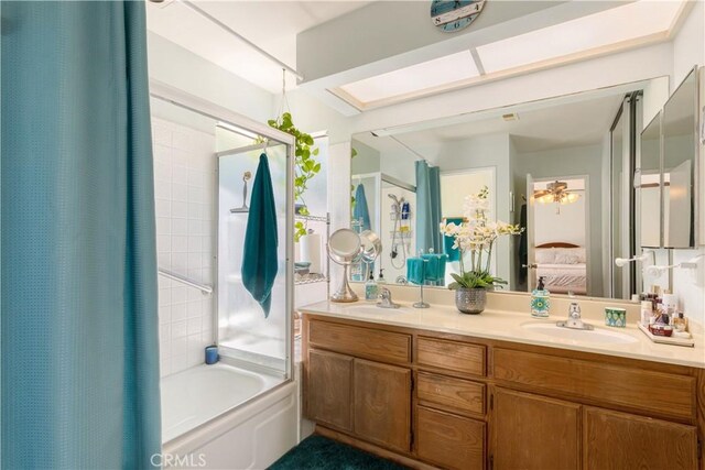 ensuite bathroom with a sink, shower / tub combo with curtain, double vanity, and connected bathroom