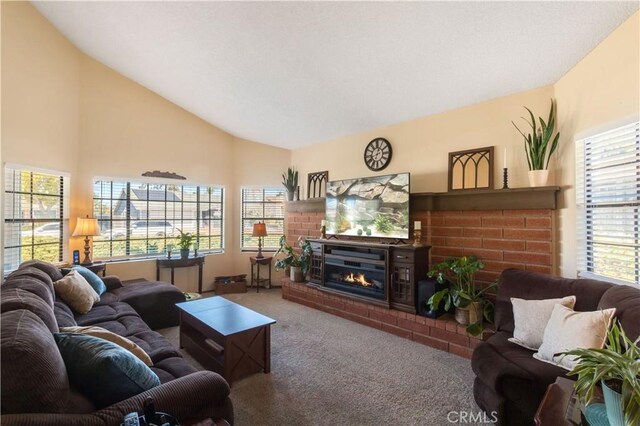 carpeted living area featuring high vaulted ceiling and a fireplace