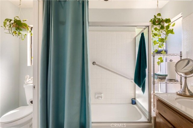 full bath featuring vanity, toilet, and shower / tub combo