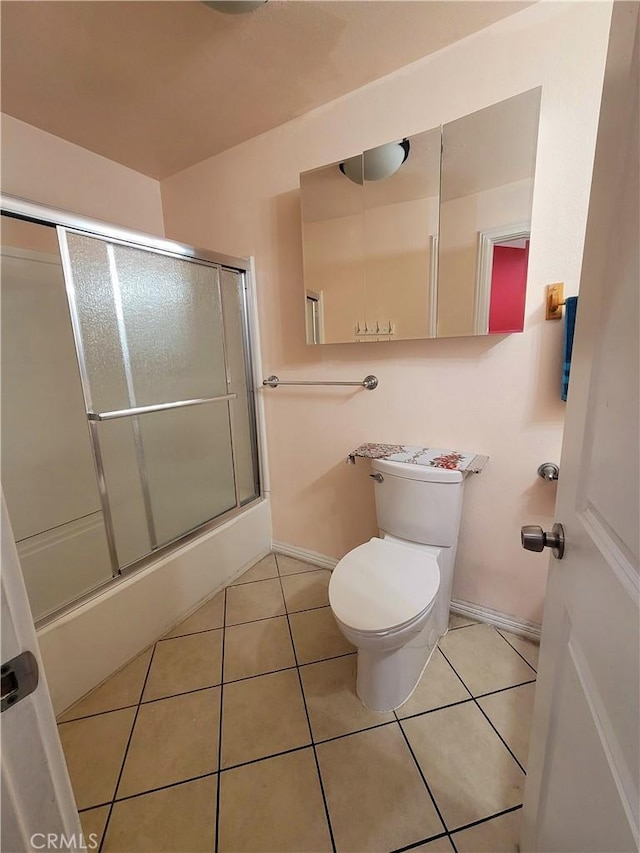 7132 Dinwiddie St, Downey, CA 90241 - bathroom featuring tile patterned floors, toilet, baseboards, and bath / shower combo with glass door