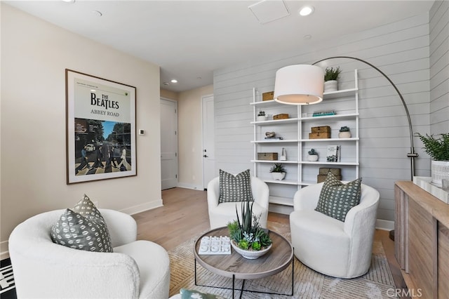 19011 Main St Unit 121, Huntington Beach, CA 92648 - sitting room featuring wood finished floors, wooden walls, baseboards, and recessed lighting