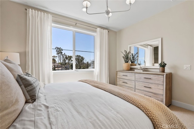 19011 Main St Unit 121, Huntington Beach, CA 92648 - carpeted bedroom with an inviting chandelier and baseboards
