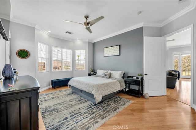 bedroom with visible vents, baseboards, ornamental molding, ceiling fan, and light wood-style floors