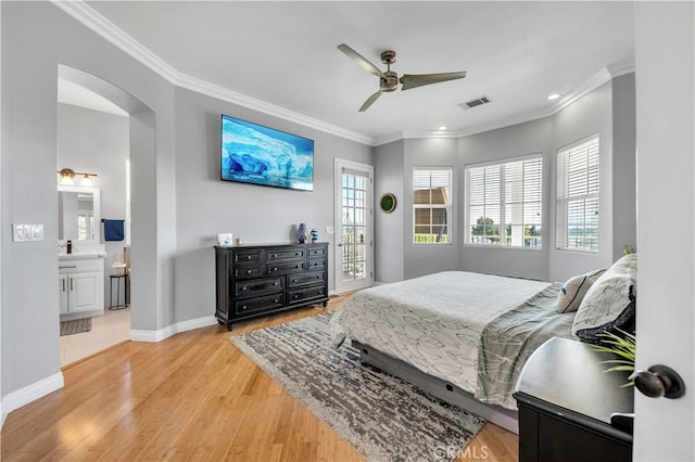 bedroom with arched walkways, baseboards, light wood-style flooring, and crown molding