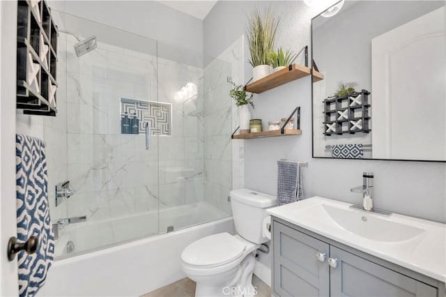 full bathroom featuring toilet, vanity, and shower / bath combination with glass door