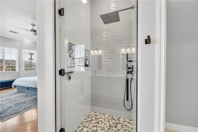ensuite bathroom with ornamental molding, a shower stall, ensuite bath, visible vents, and wood finished floors