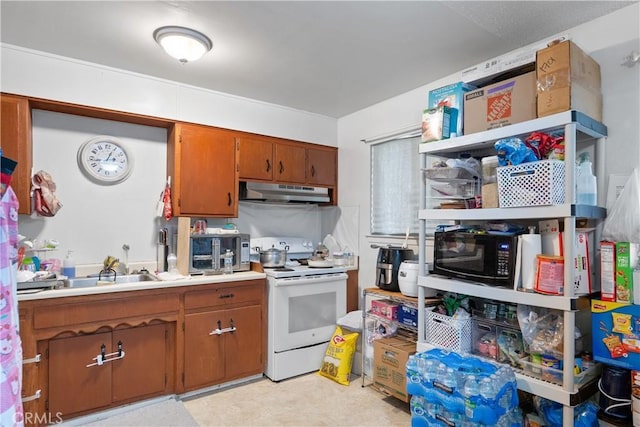 kitchen featuring black microwave, under cabinet range hood, light countertops, brown cabinets, and electric range