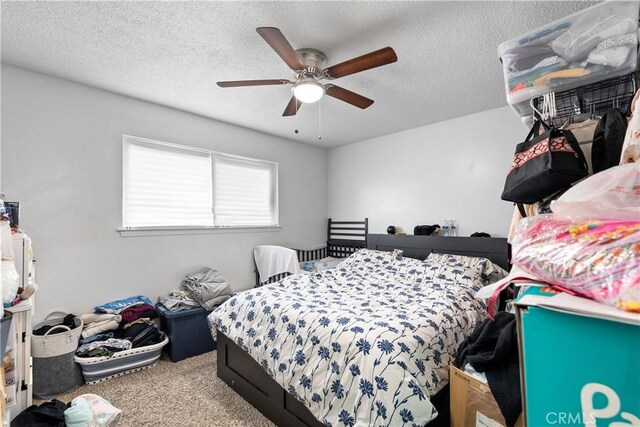 bedroom featuring a textured ceiling, carpet, and a ceiling fan