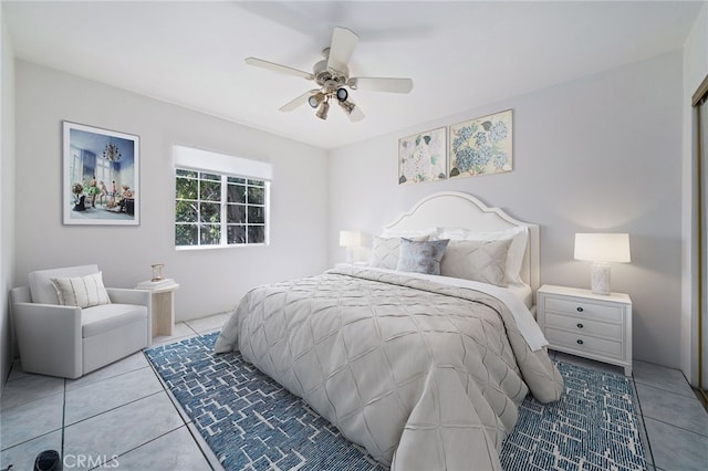 tiled bedroom featuring a ceiling fan